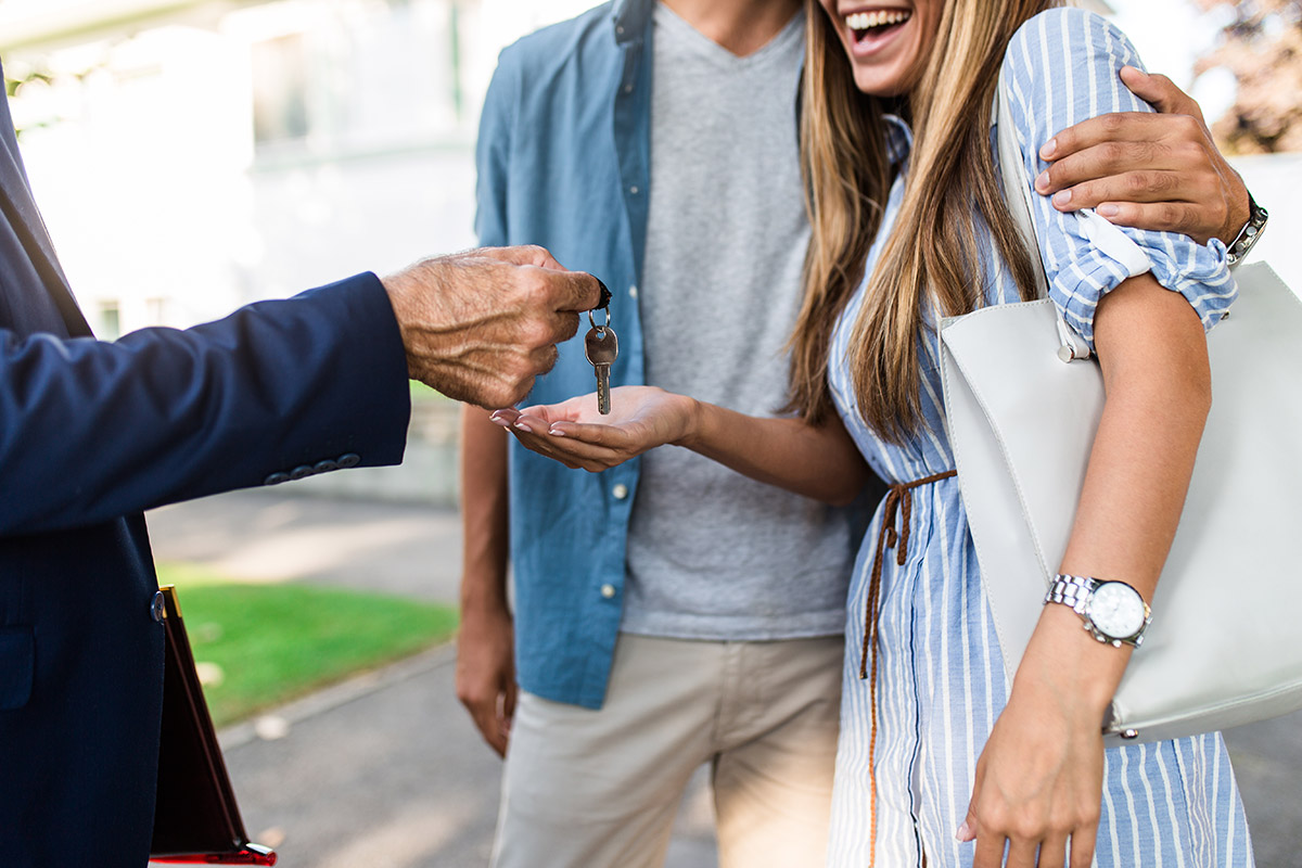 Couple getting handed the keys to a new home