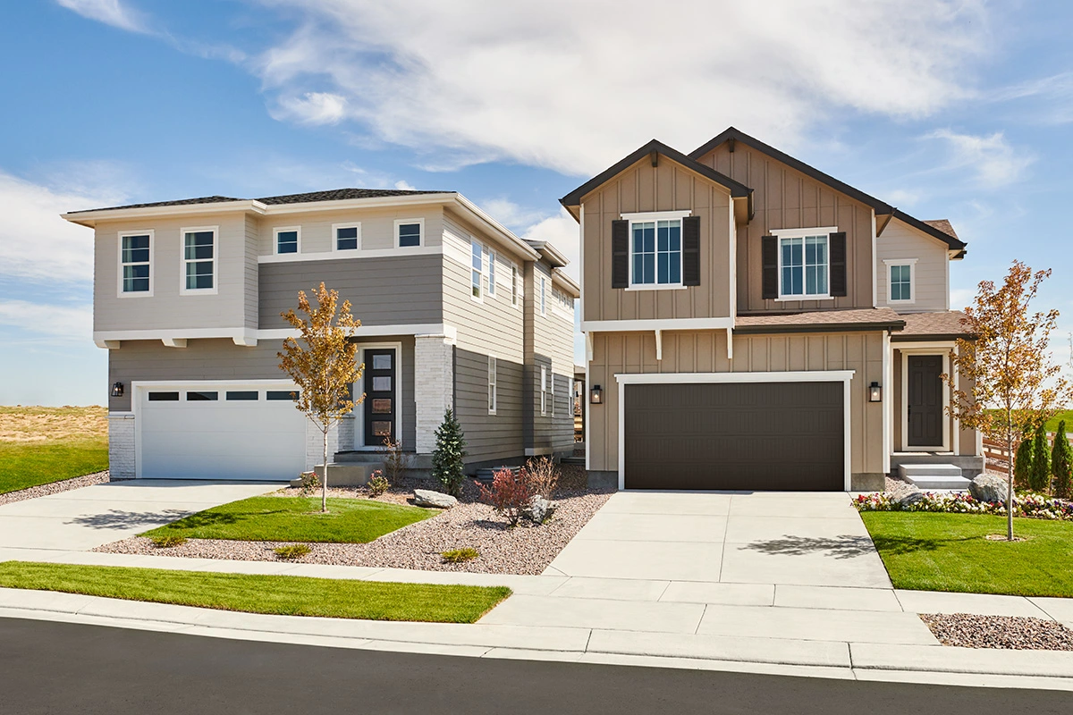 Two homes on a street, both with two-car garages and landscaped yards