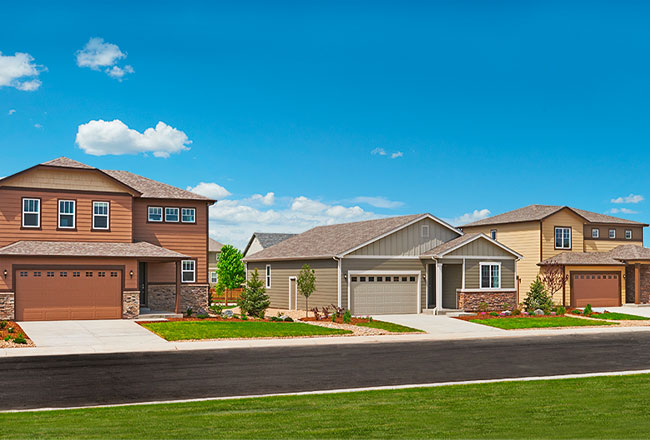 Three bedrooms on the street, all with two-car garages and stone accents