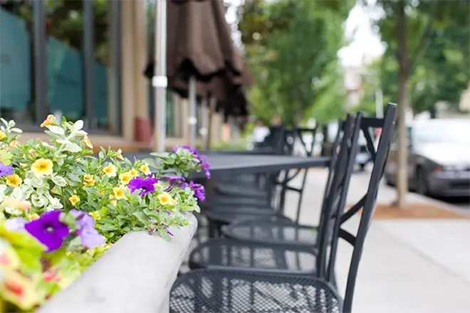 Tables and chairs in front of an outdoor restaurant patio