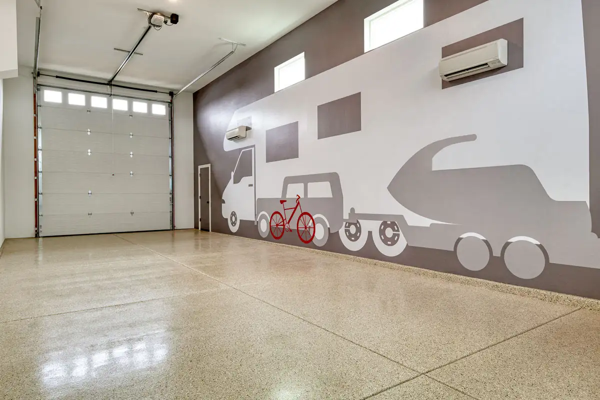 Interior of Ultragarage with mural of RV, car towing boat, and bike