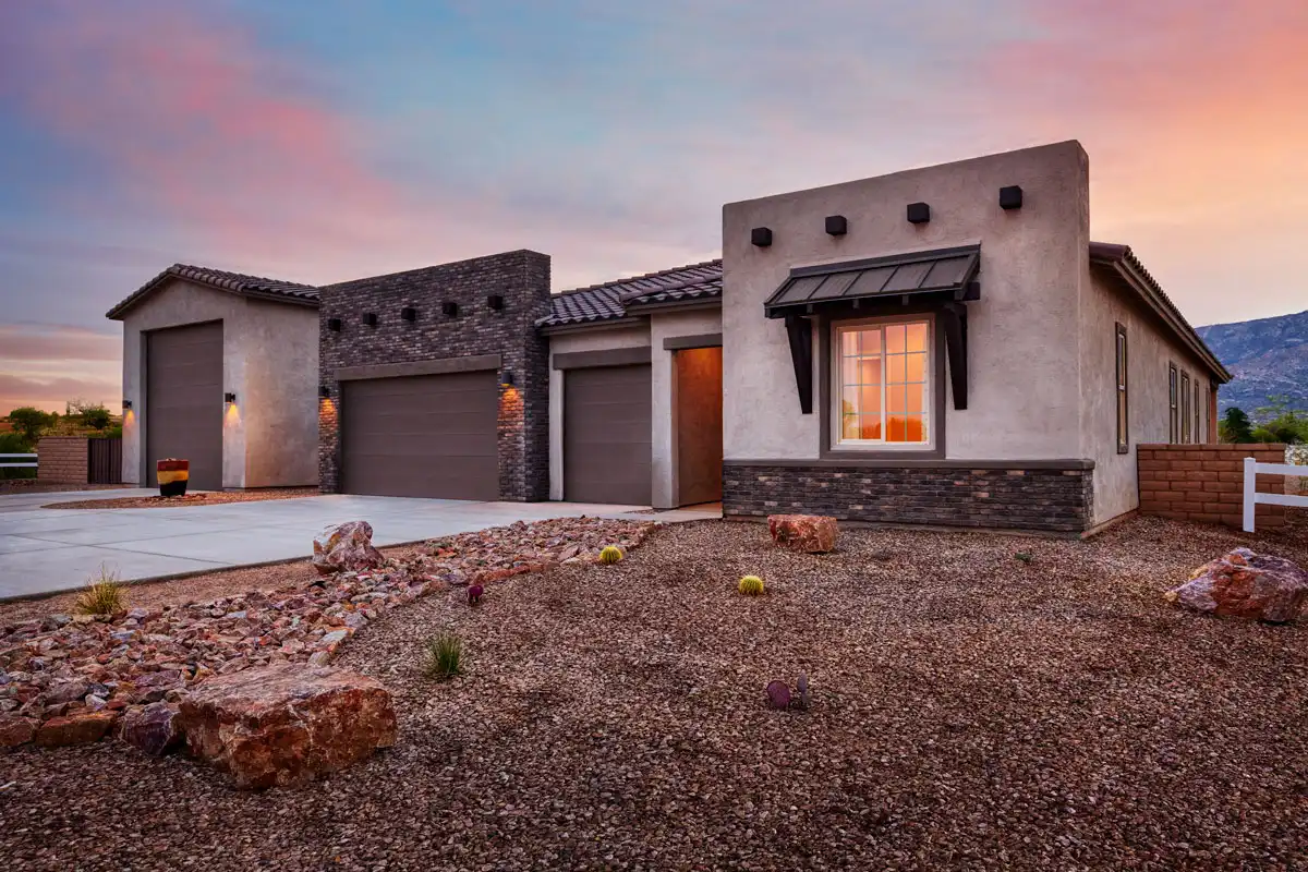 Exterior of one-story home with gravel lawn and Ultragarage