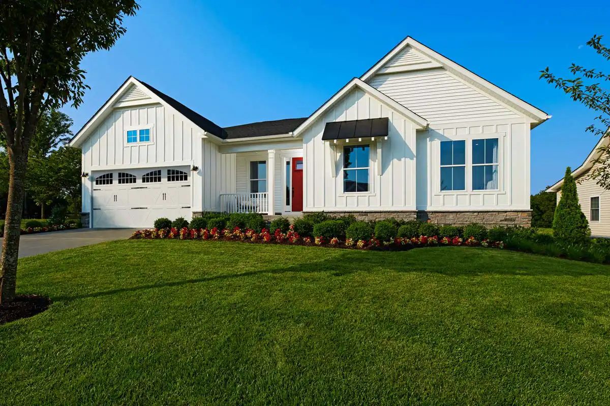 Exterior of white one-story home with two-car garage and small front porch