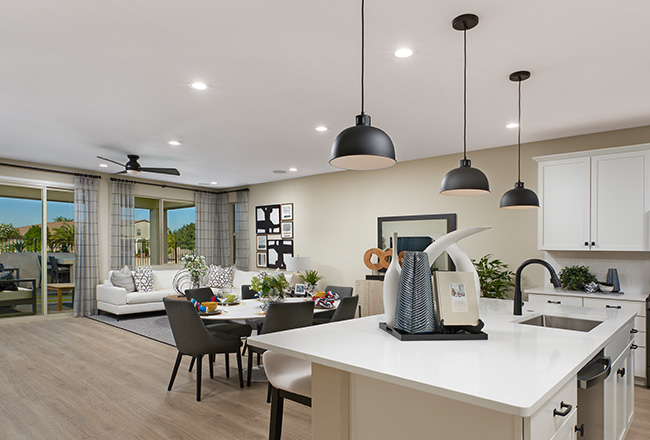 Kitchen island, dining table, and living room area with sliding doors behind