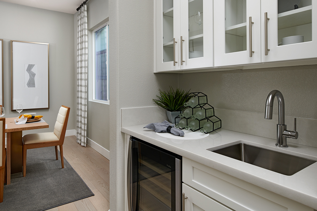 Wet bar with wine frig next to dining area