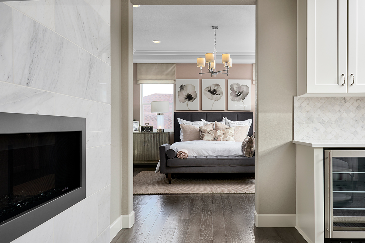 View through doorway to primary owner's bedroom with bed and nightstand