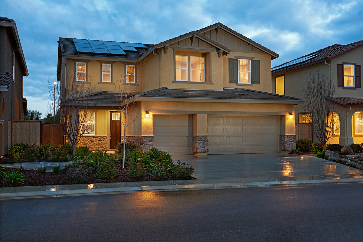 Two-story home with three-car garage and solar panels on the roof