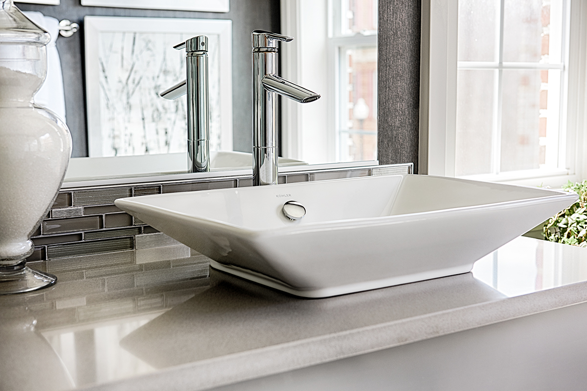 Bowl sink with tall glossy silver faucet